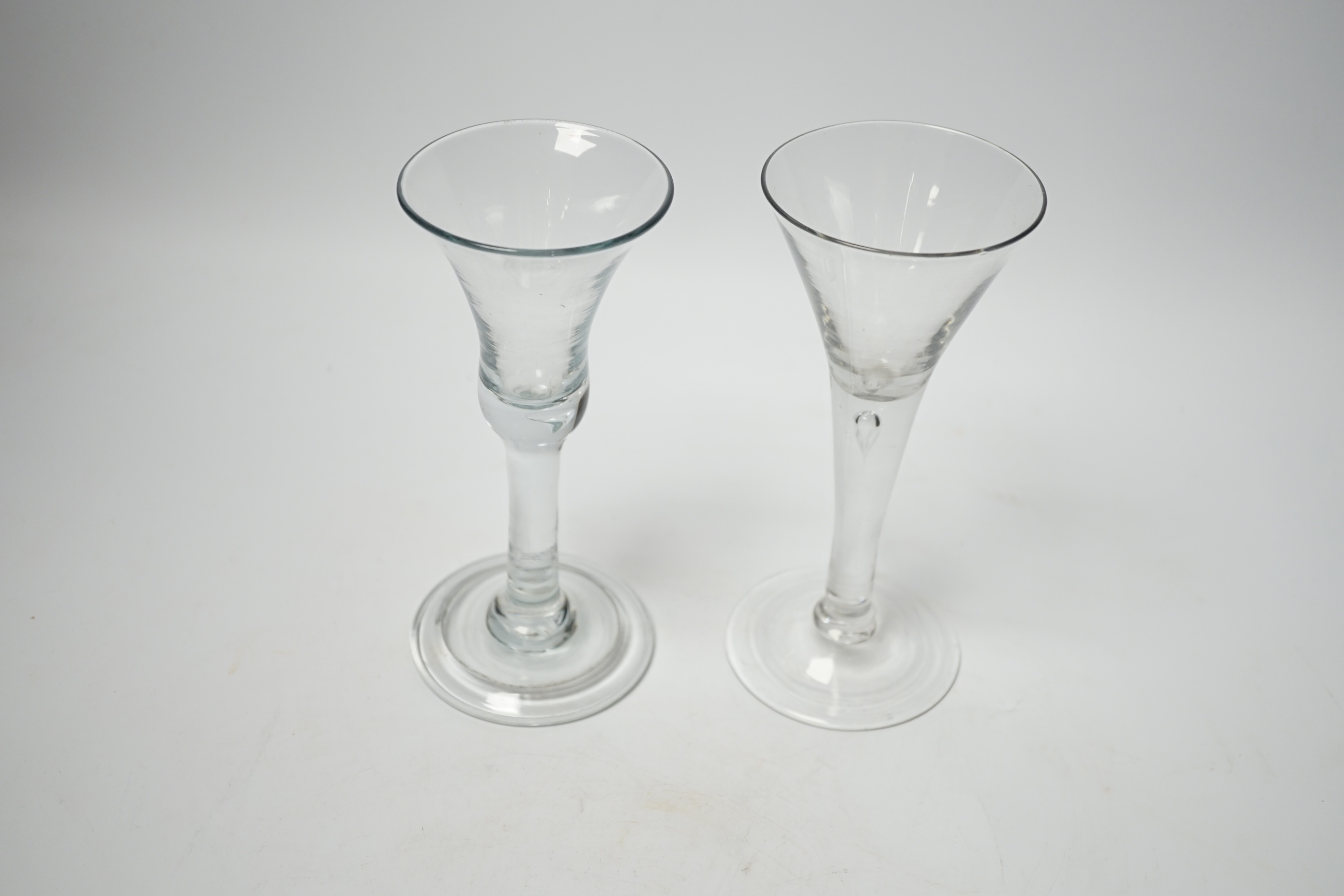 Two Georgian wine glasses, both with plain stems one with tear, the other with bell-shaped bowl and folded foot, the other with trumpet-shaped bowl, both 16.5cm